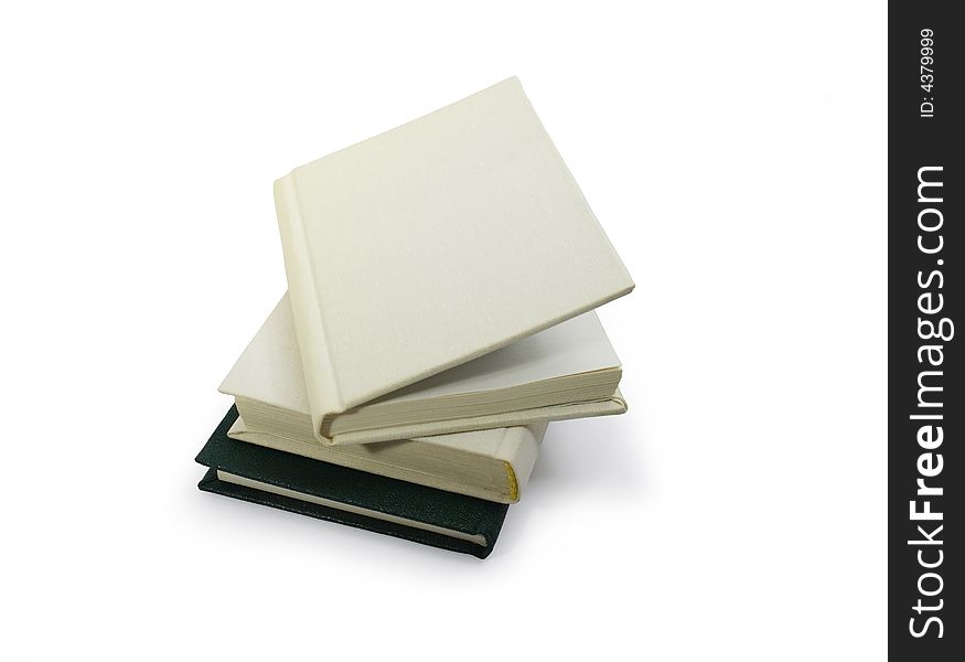 Three hardcover books lying on white background