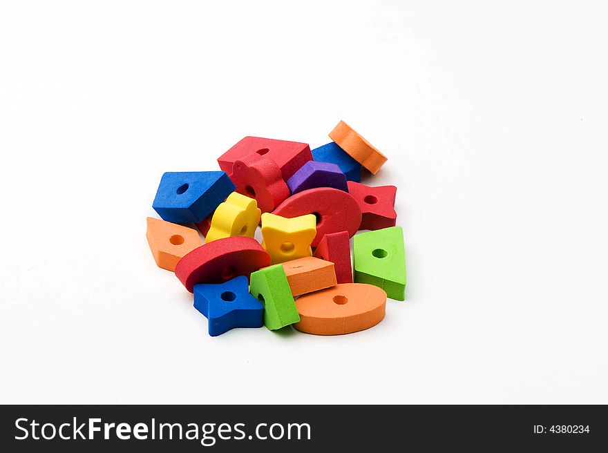 Multicolored toys in orange, red, green, purple and blue. Different shapes. Isolated on white background. Multicolored toys in orange, red, green, purple and blue. Different shapes. Isolated on white background.