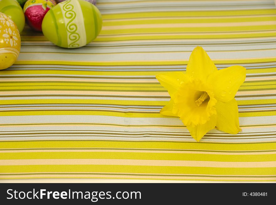 Flower head and easter eggs on a striped background. Flower head and easter eggs on a striped background.