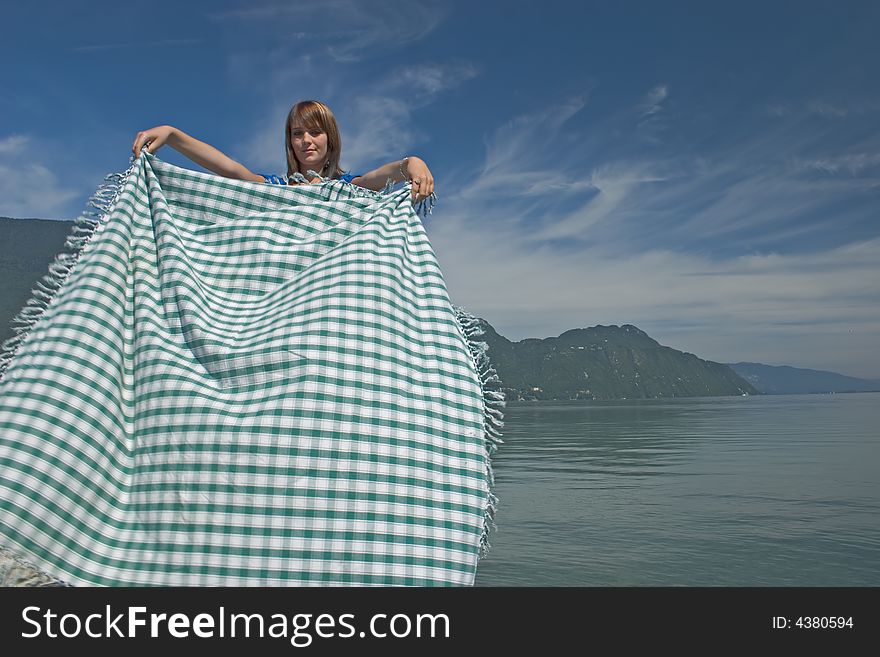 Woman extending a tablecloth