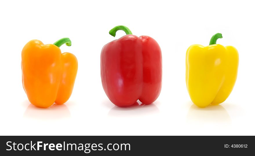 Colored peppers on white background