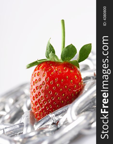 Strawberry laying on a white background among a chain. Strawberry laying on a white background among a chain