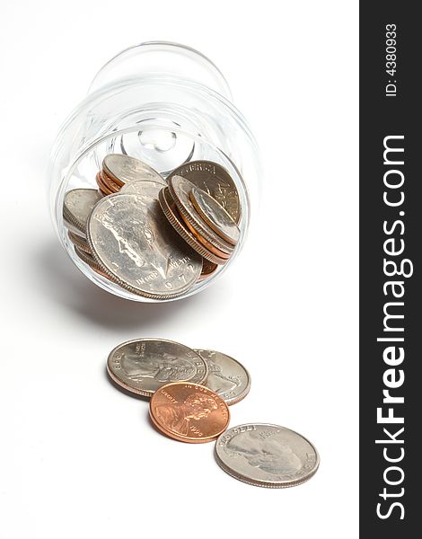 Coins in a glass on a white