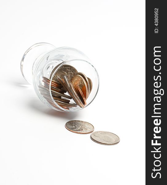 Coins in a glass on a white