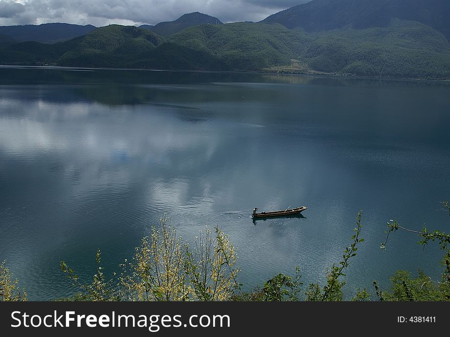 It's a early autumn day. A local sigle boat in lugu lake. It's a early autumn day. A local sigle boat in lugu lake.