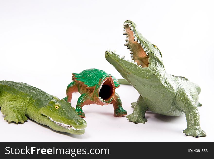 Crocodiles and reptile toys macro on the white background. Crocodiles and reptile toys macro on the white background