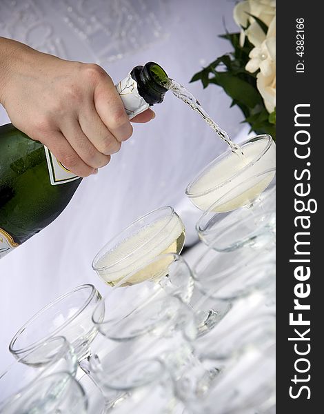 Waiter pouring champagne for a toast to the bride and groom. Waiter pouring champagne for a toast to the bride and groom