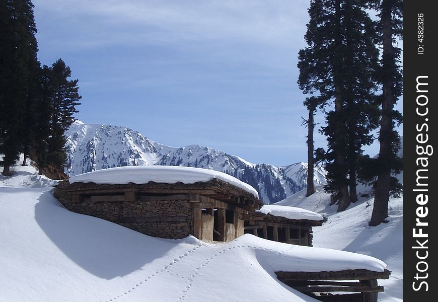 Snow covered cattle shelters in hills of Jammu(india) called dhokes. used by the villagers during grazing months. Snow covered cattle shelters in hills of Jammu(india) called dhokes. used by the villagers during grazing months.