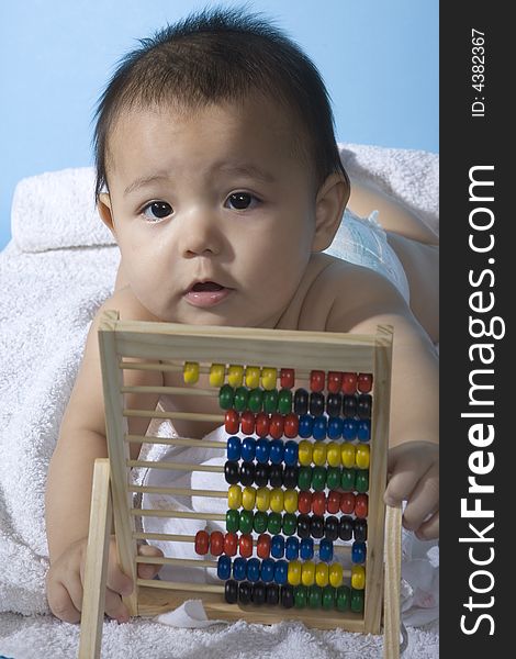 Small charming baby with a calculating machine. Small charming baby with a calculating machine