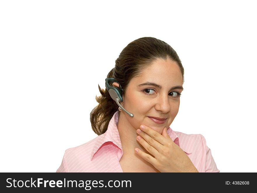 A girl, wearing a blue-tooth earpiece, listening and smiling. A girl, wearing a blue-tooth earpiece, listening and smiling