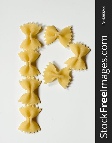 Letter P written with farfalle pasta on white background