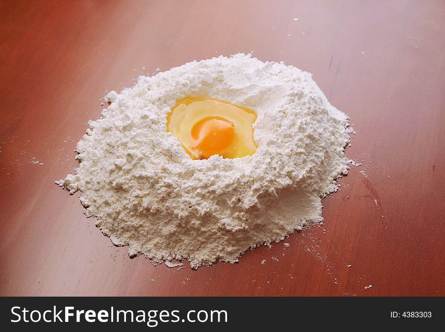 Flour and egg on wooden table. Flour and egg on wooden table