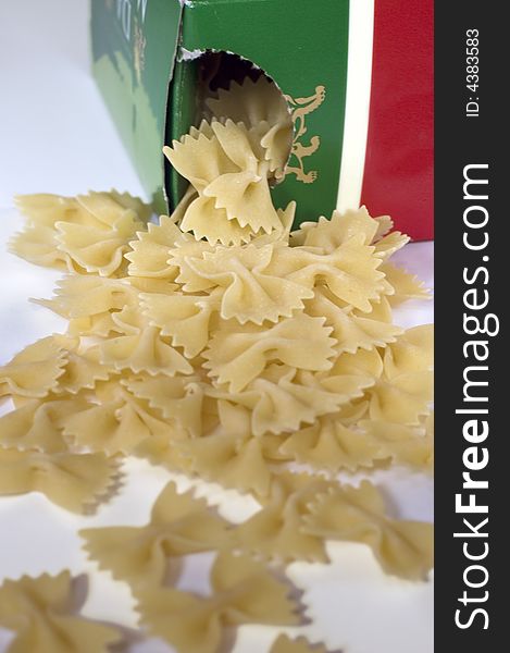 Farfalle pasta spilling out from the box on white background
Focus on the box