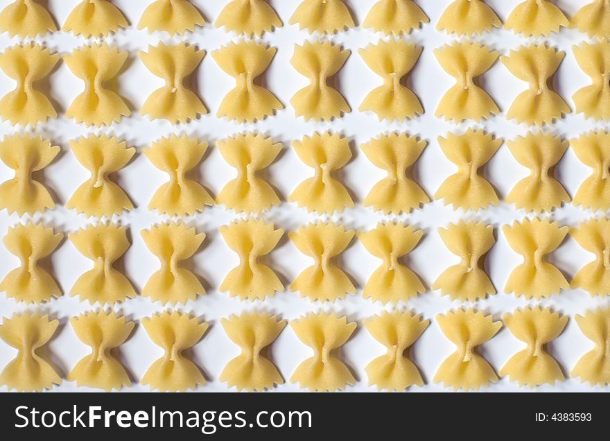 Farfalle pasta pattern on white background