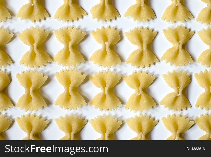 Farfalle pasta pattern on white background