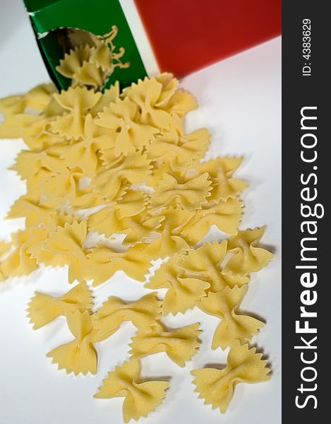 Farfalle pasta spilling out from the box on white background
Focus on the front