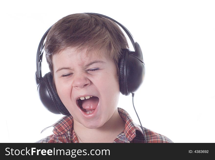 The little boy listens to music and sings a song. The little boy listens to music and sings a song