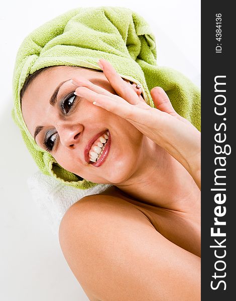 Woman with towel on head smiling to the side, Gentle overhand. Woman with towel on head smiling to the side, Gentle overhand.