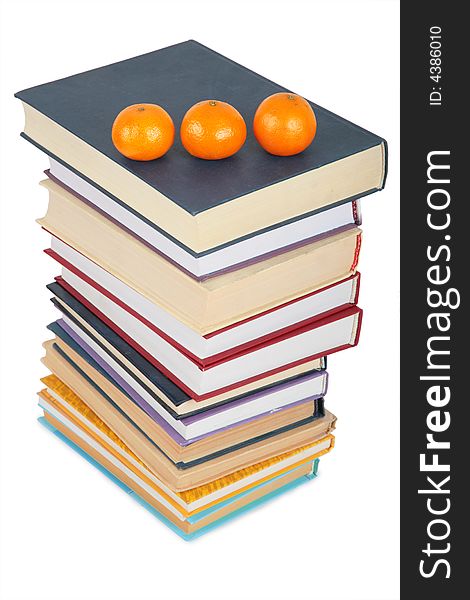 Stack of books with three mandarins on white