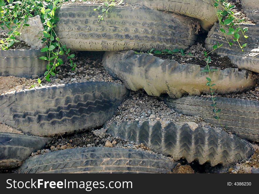 A rockery made up of old tractor tires. A rockery made up of old tractor tires