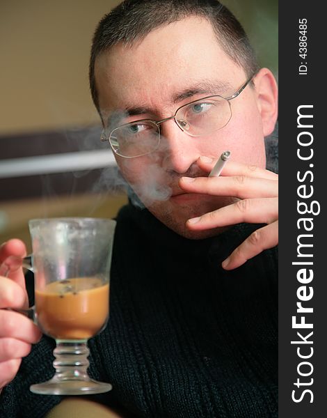 Man with glass and cigarette