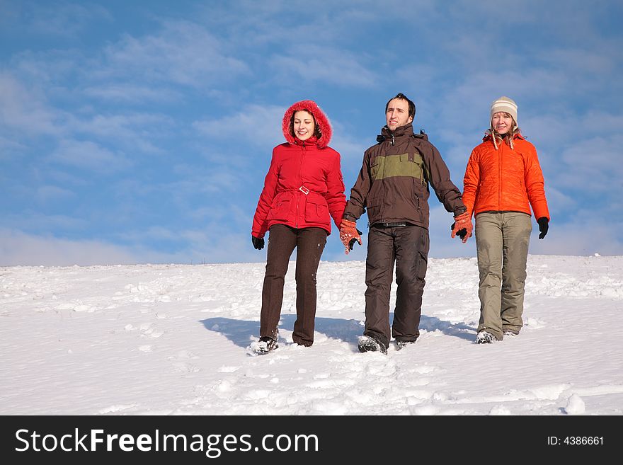 Three friends walk on snow on hillside 2. Three friends walk on snow on hillside 2