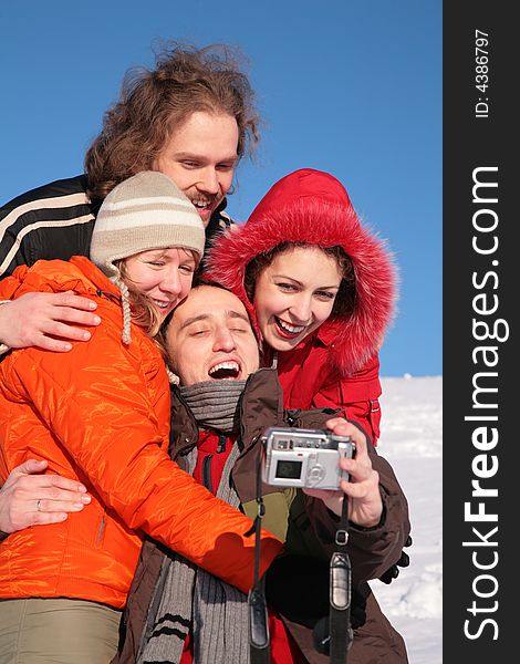 Group of friends taking photographs of themselves on a winter day. Group of friends taking photographs of themselves on a winter day.