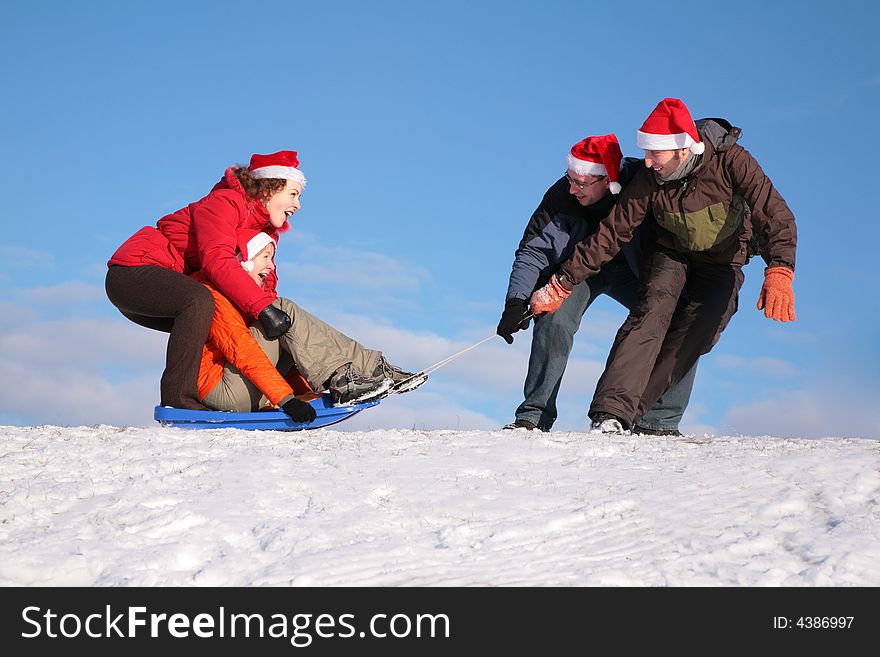 Two Men Pull Two Women On Sled