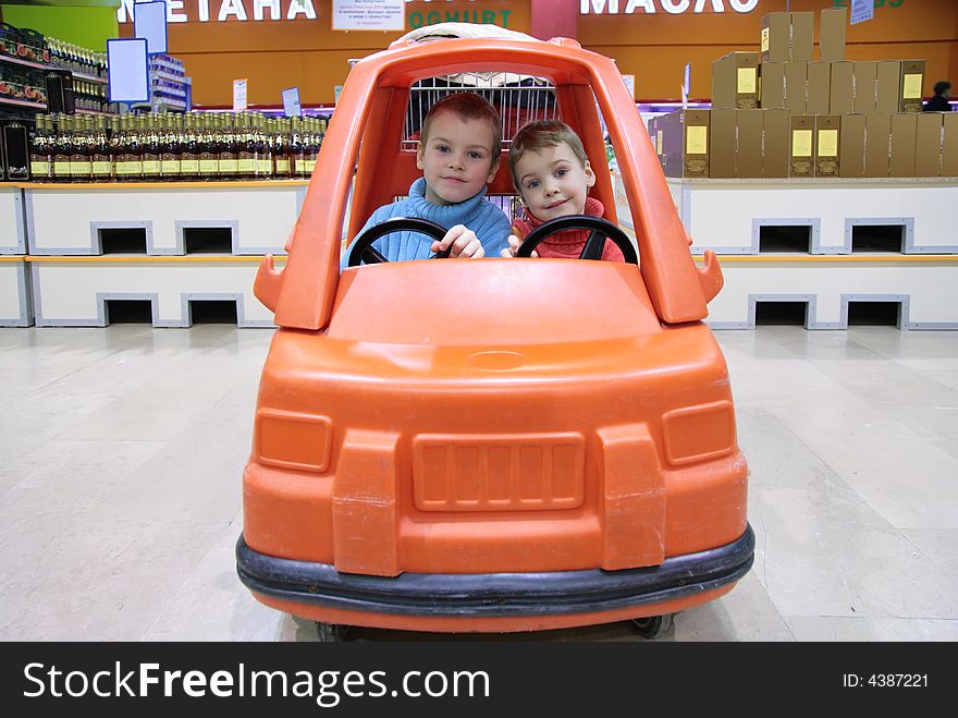 Children in toy automobile in supermarket 2. Children in toy automobile in supermarket 2