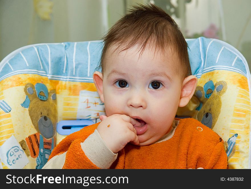 The small child sits at a children's little table. The small child sits at a children's little table