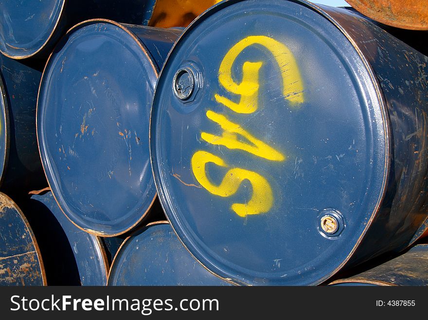 Stacked blue metal gas drums.