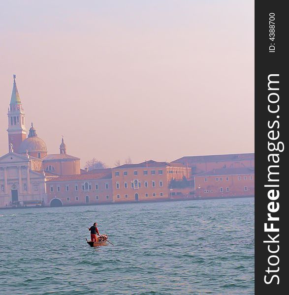 Gondolier in Venice crossing Giudecca towards Isola di San Giorgio Maggiore basilica