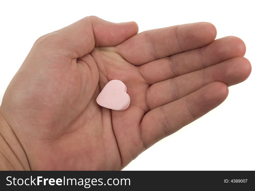 Hand with heart shaped sweet isolated on a white background