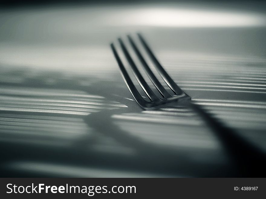 A fork lightened under filtered light