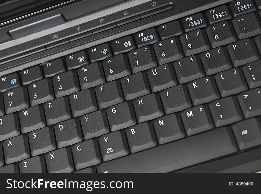 Black modern notebook keyboard close up