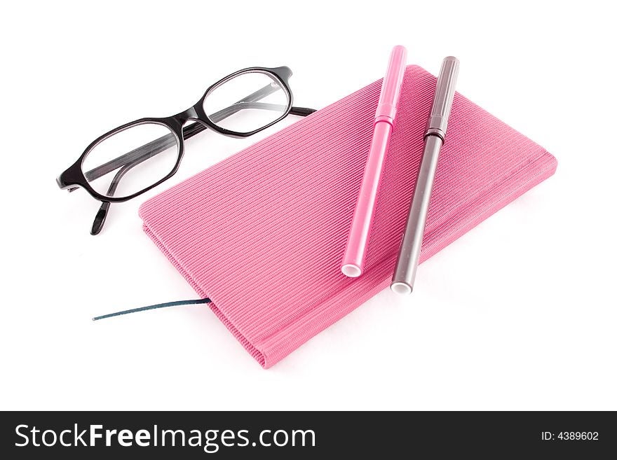 Purple book, black glasses and markers isolated on a white background. Purple book, black glasses and markers isolated on a white background