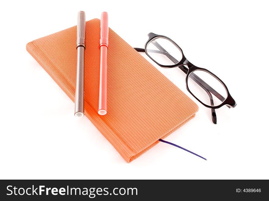 Red calendar and black glasses isolated on a white background