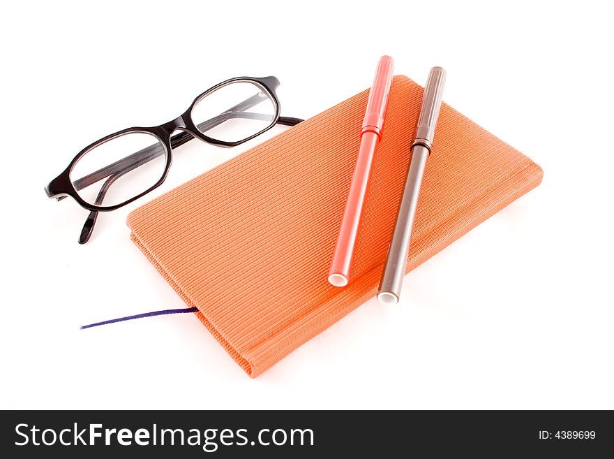 Red calendar and black glasses isolated on a white background