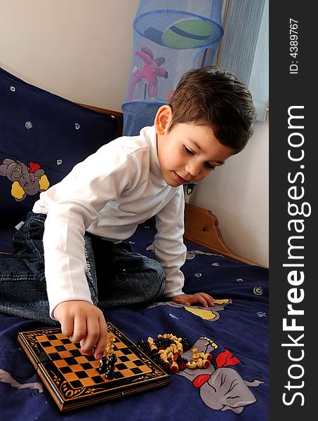 A little boy playing chess