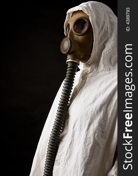 Person in gas mask on dark background