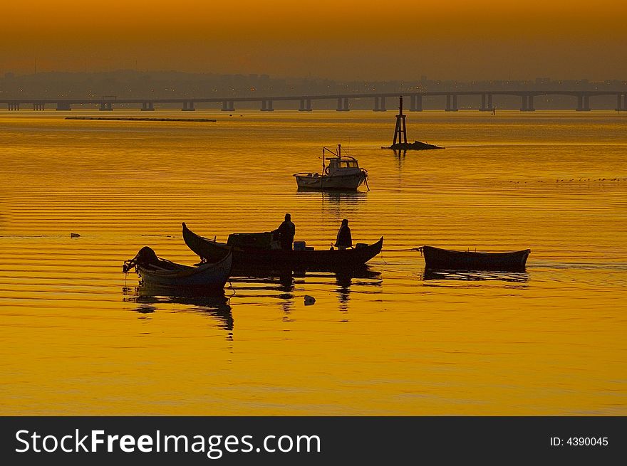 Fishing boats anchorage harbour  by sunset at River Tagus Estuary, Alcochete, Portugal, EU. Fishing boats anchorage harbour  by sunset at River Tagus Estuary, Alcochete, Portugal, EU.