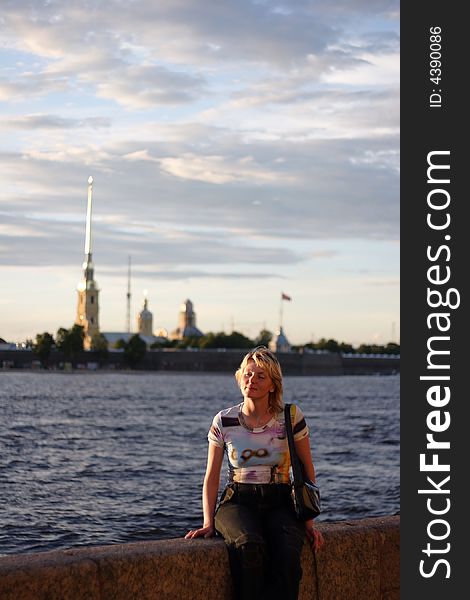 Girl sitting on canal border in Saint Petersburg