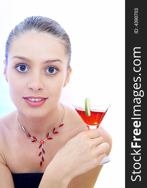 High-key portrait of young woman with cocktail  in multicolor back lights. Image may contain slight multicolor aberration as a part of design