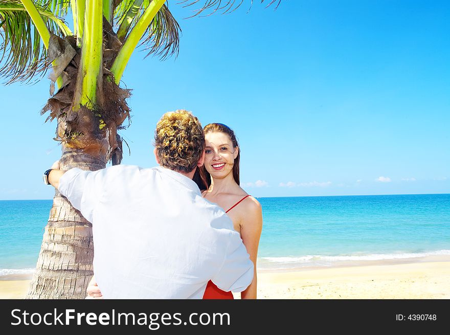 A portrait of attractive couple having date on the beach. A portrait of attractive couple having date on the beach