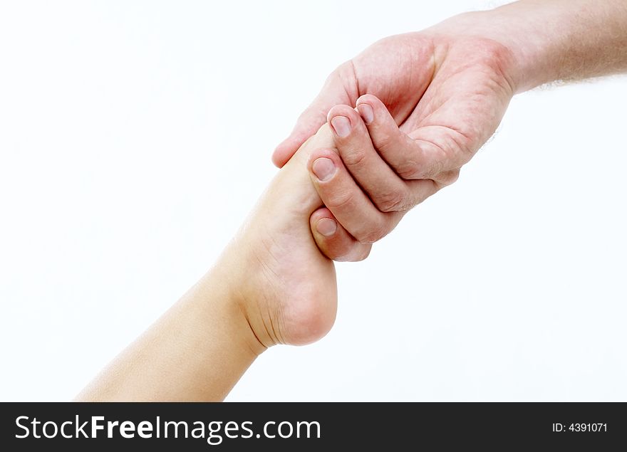 View of man’s hand holding baby’s toe on white background. View of man’s hand holding baby’s toe on white background