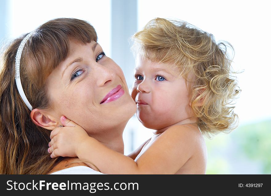High key portrait of happy mother with baby. High key portrait of happy mother with baby