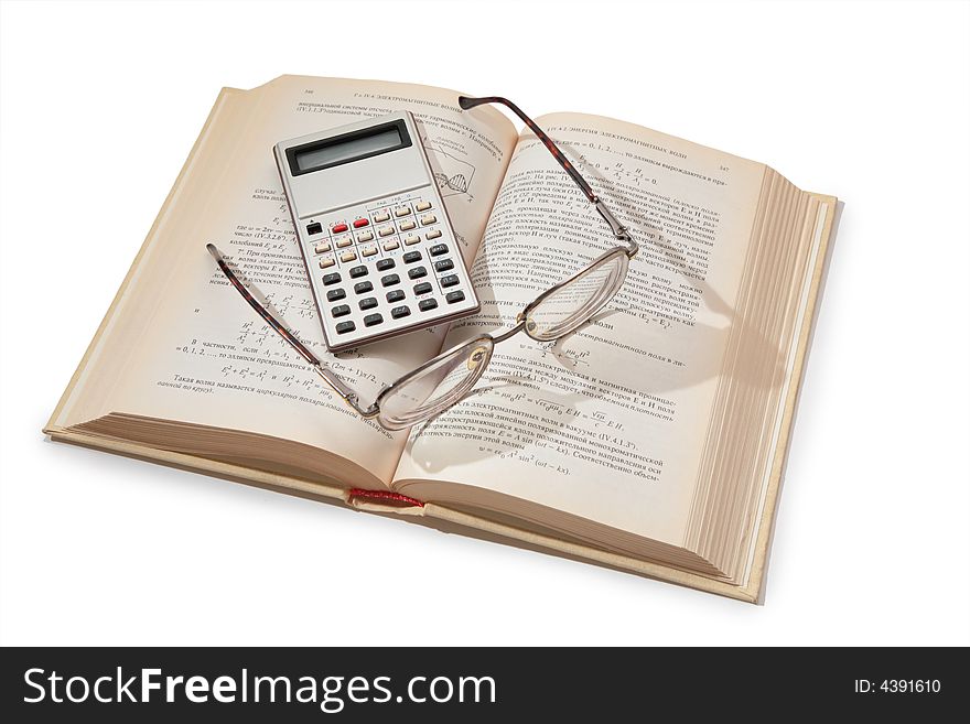 Calculator and glasses on opening textbook. Calculator and glasses on opening textbook