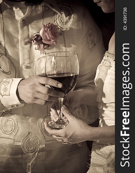 Bride and groom sharing wine (take communion) during their wedding. Bride and groom sharing wine (take communion) during their wedding