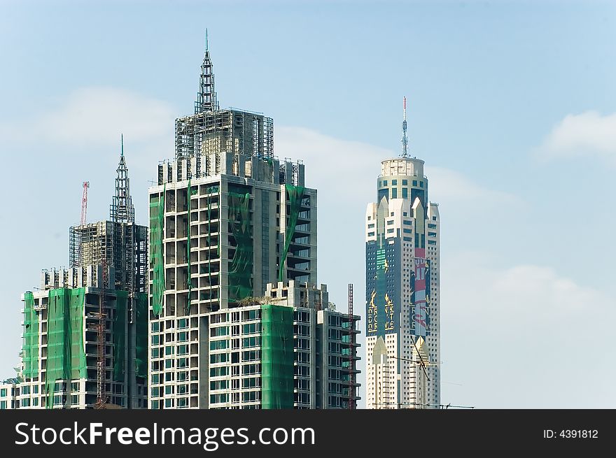 Tall skyscrapers in bangkok against blue sky