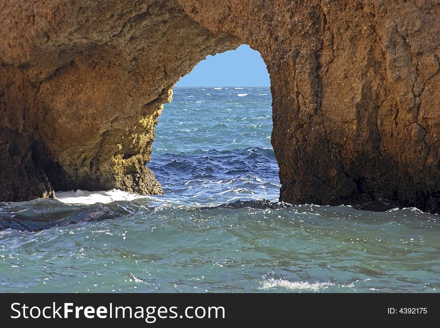 Hole in a rock in the atlantic ocean in Portugal